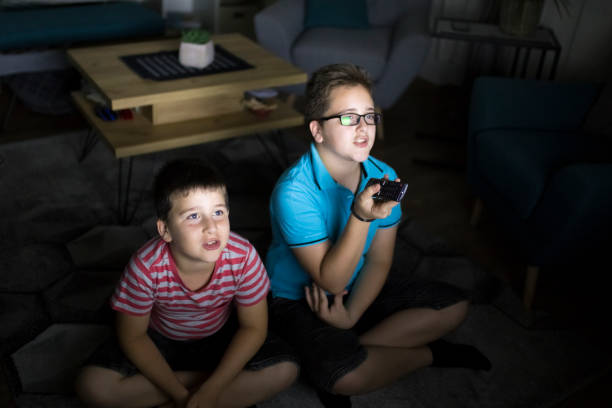 istock Boys watching a movie at home at night 1223772652