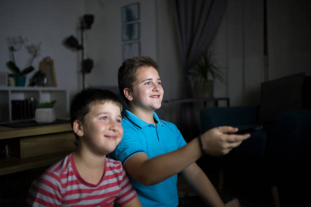 istock Boys watching a movie at home at night 1223772719
