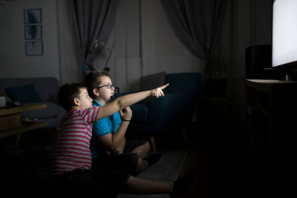 istock Boys watching a movie at home at night 1223772971