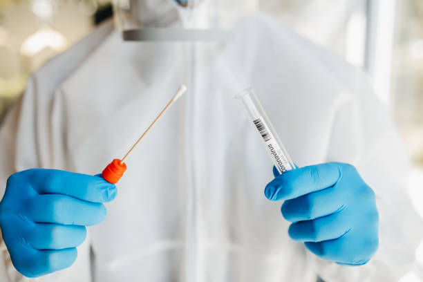 istock Doctor in protective suit opening a swab 1223774001