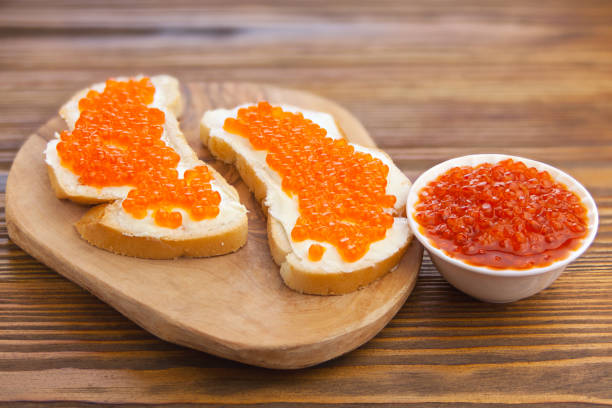 istock delicious appetizing sandwich with red caviar on  wooden 1223776126