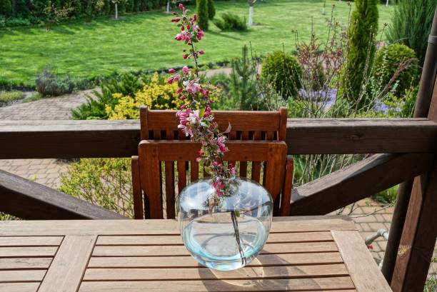 istock a round laid flowerpot with cherry branches and red flowers 1223780418