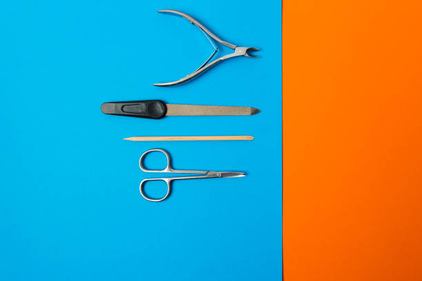 istock manicure set on a blue background on an orange background 1223781096