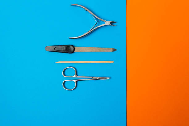istock manicure set on a blue background on an orange background 1223781104