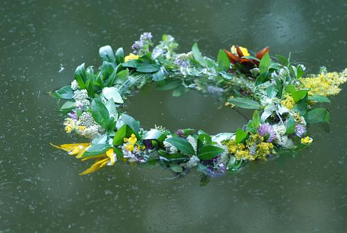 Holiday of Ivan Kupala. Wreath of flowers on water.