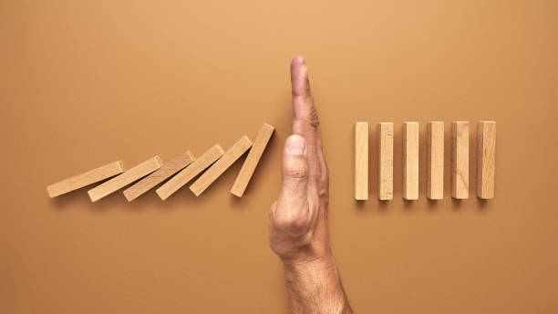 istock A risk management specialist stops domino blocks falling 1223785312