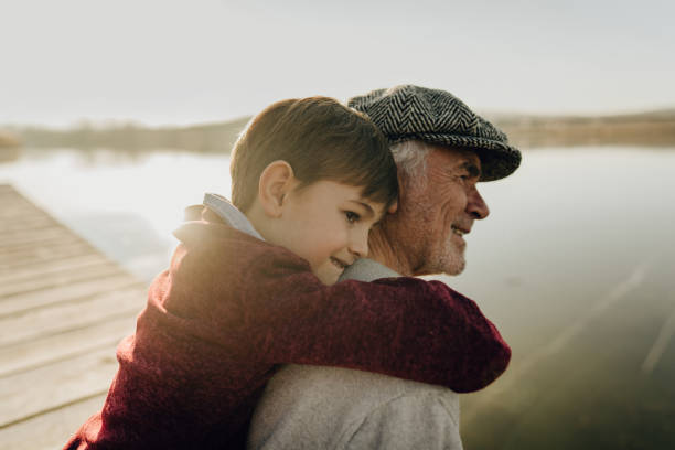 istock Grandfather and grandson on a lake dock 1223789062