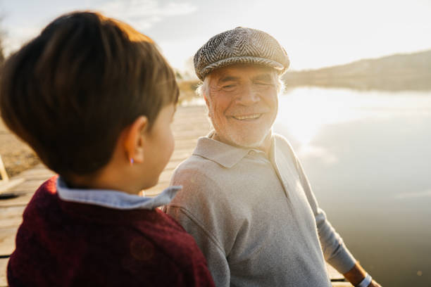 istock Grandfather and grandson on a lake dock 1223789124