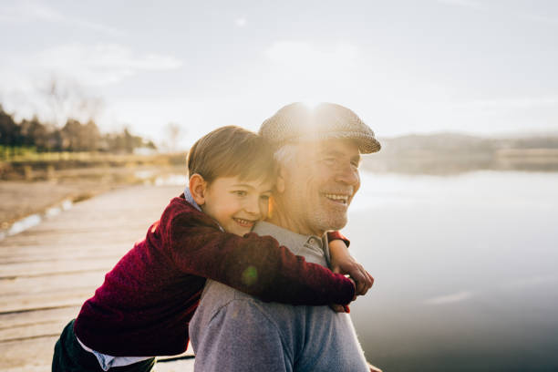 istock Grandfather and grandson on a lake dock 1223789215