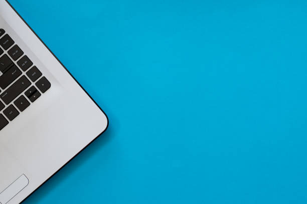 istock Laptop top view on blue background, copy space 1223789255