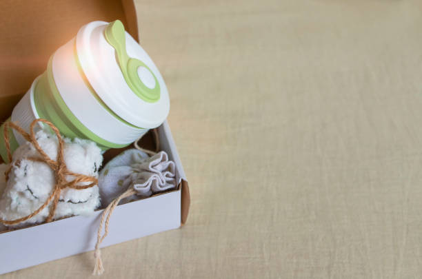 istock Delivery of box with collapsible silicone mug, mesh bag and reusable cotton discs set 1223790430