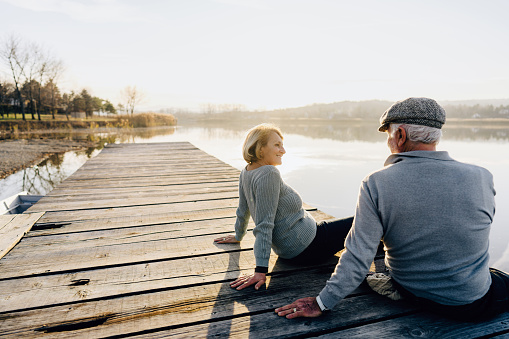 Photo of a senior couple on a lake dock