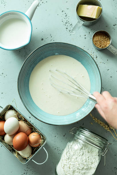 istock Kitchen - pancake batter in a bowl - eggs, milk, flour, butter around. 1223790629