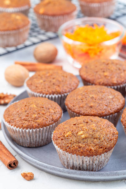 istock Homemade carrot cake muffins with walnuts on gray plate, vertical 1223791750