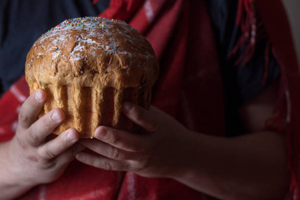 istock Male hands hold Easter cake near the window 1223795400