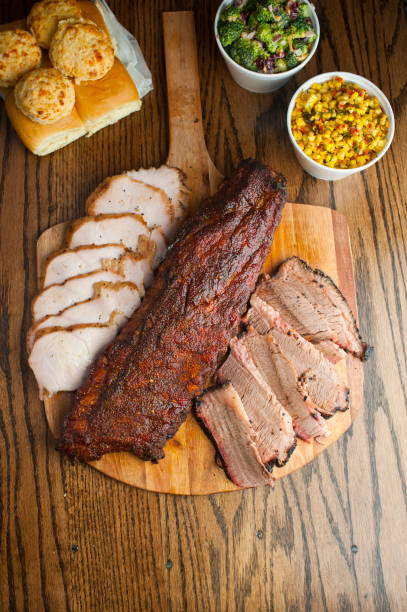 istock Barbecue. Picnic BBQ table spread. Beef brisket, chicken, pork ribs, beef ribs, Mac n cheese, cornbread, Brussels sprouts, coleslaw, and beer. Classic traditional Texas bbq meats and side dishes. 1223797858