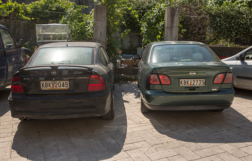 limenas license plated cars parked in thassos island of kavala greece