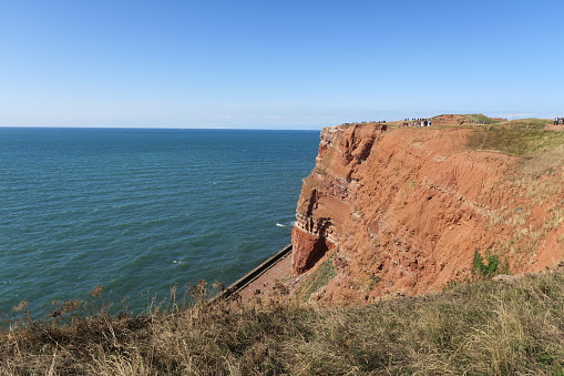 The rocky island of Helgoland is located in the German Bight and consists of red sandstone. From up there, tourists have a beautiful view of the sea.