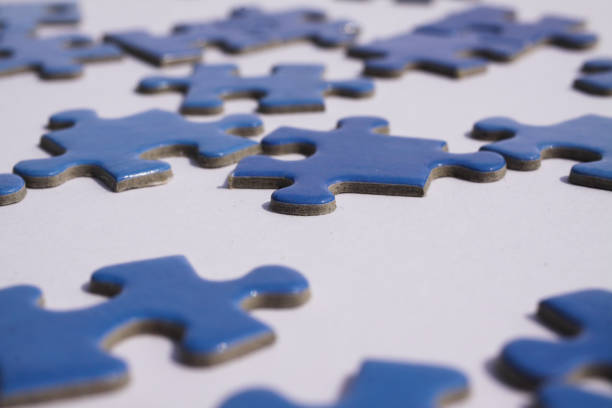 istock Close up of isolated blue puzzle pieces, white background 1223806857