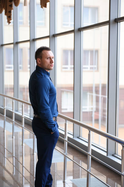 istock businessman looking through the phone by the window 1223807058