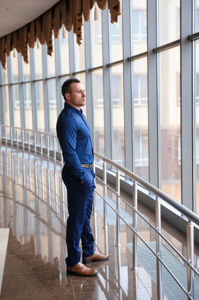 istock businessman looking through the phone by the window 1223807122