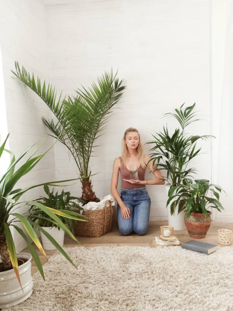 istock Young girl meditating over green plants. 1223808074