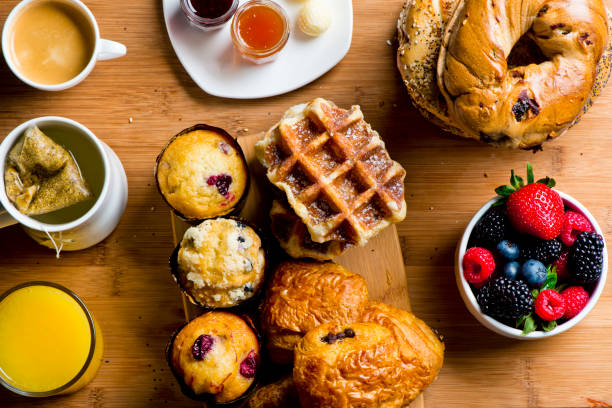 istock Breakfast or brunch buffet. Bagels, blueberry muffins, croissants, cinnamon rolls, scones, sunny side up eggs, bacon, butter, jelly, and cream cheese. Classic American or French breakfast. 1223810141