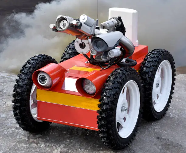 Photo of little robot fireman on smoke background