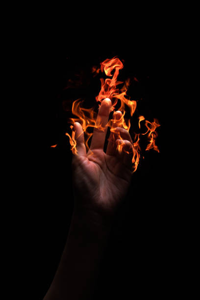 istock Flame in a woman's hand isolated on black background 1223811042