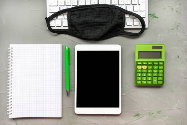 istock Home office background. Mask and notebook on gray 1223814356