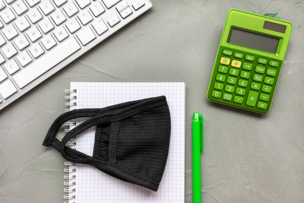 istock Home office background. Mask and notebook on gray 1223814361