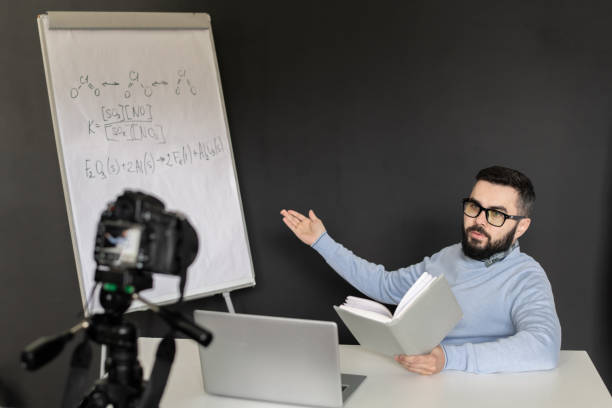 istock Confident teacher of chemistry explaining his students formulas on whiteboard 1223814419
