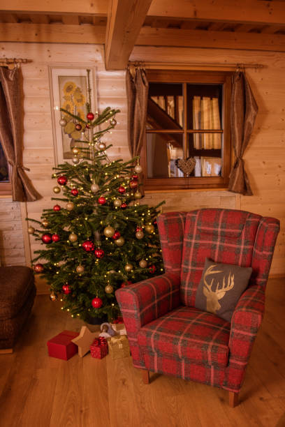istock red checked chait next to a decorated christmas tree living room 1223817131