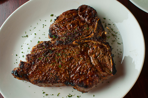 Steak. Grass-fed skirt steak, grilled to a medium rare and served with a garlic herb butter sauce and paired with roasted potatoes and Brussels sprouts. Classic American steakhouse favorite.