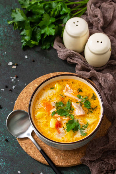 istock Norwegian soup with cream and salmon on a dark stone background. 1223823117