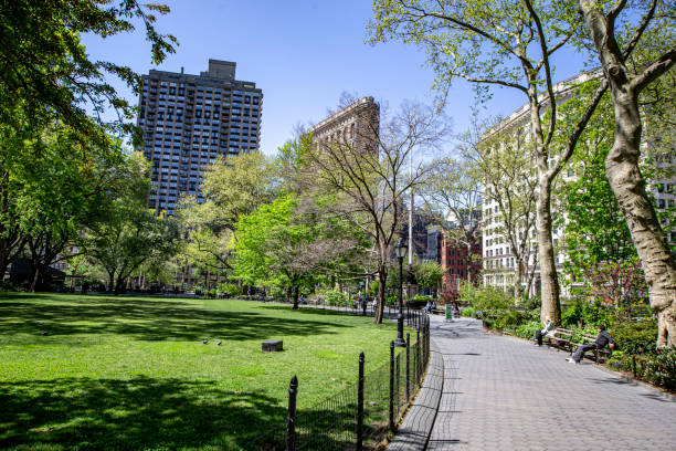 Madison Square Park New York, New York - USA – May 7, 2020:  Madison Square Park is quiet due to health concerns to stop the spread of COVID-19 outbreak on Thursday, May 7, 2020. bridge crossing cloud built structure stock pictures, royalty-free photos & images