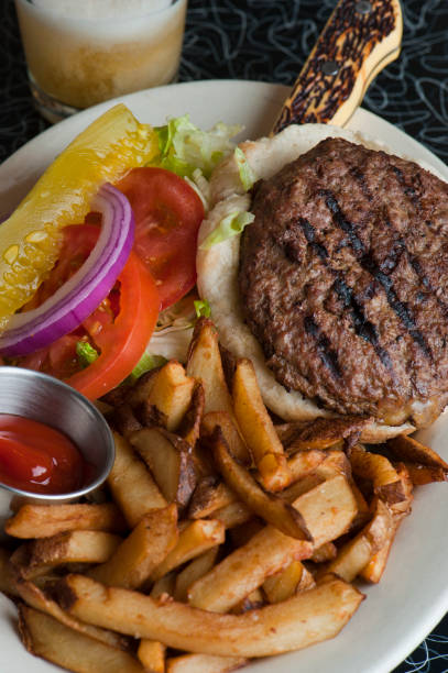 istock Bacon cheeseburger. Classic American style Burger with two patties, crispy Bacon, melted Swiss cheese, caramelized onions on a toasted brioche and served with crispy French fries. Bar favorite. 1223824582