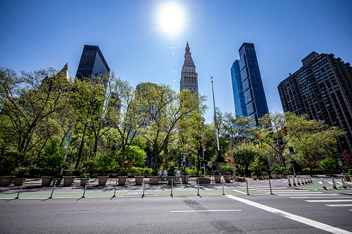 New York, New York - USA – May 7, 2020: The Flatiron Building across from Madison Square Park is quiet due to health concerns to stop the spread of COVID-19 in New York City on Thursday, May 7, 2020.