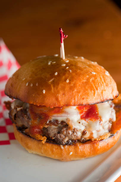 istock Bacon cheeseburger. Classic American style Burger with two patties, crispy Bacon, melted Swiss cheese, caramelized onions on a toasted brioche and served with crispy French fries. Bar favorite. 1223826156