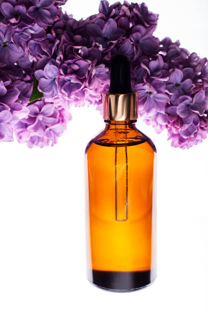 istock Bottle of Spa essential oil for aromatherapy with flowers 1223826348