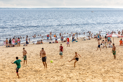 Coney Island, New York, USA - August 20th 2023:  People on the famous beach on a sunny day