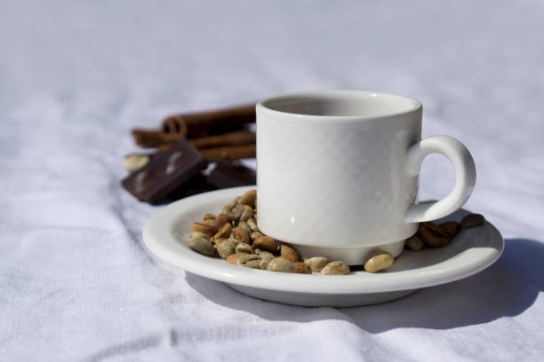 istock Coffee composition  with  white cup    of coffe  and beans of coffe, cinnamon, Chocolate,  on  linen tableclothtable 1223827732