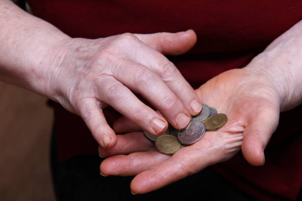 istock The pensioner's hands count coins. Russian roubles. 1223829100