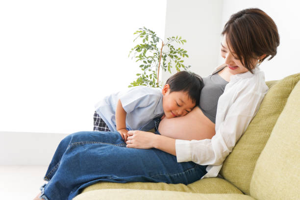 istock Little boy hear the beating of baby 1223829111