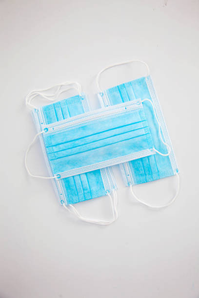 istock Blue protective medical masks lie on a white background 1223829143
