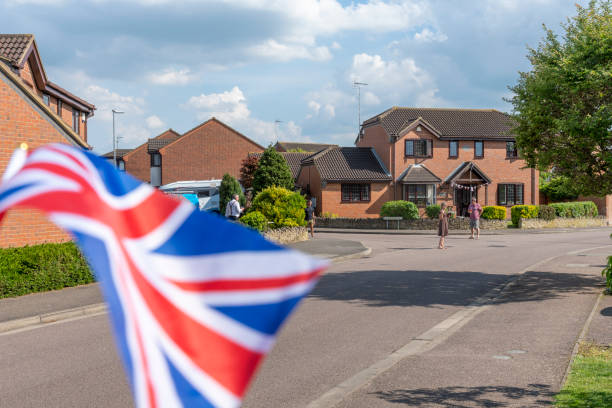 VE Day 75th anniversary, Socially distanced celebration. A socially distanced street party for the 75th anniversary of the Second World War, Victory in Europe Day. There are people on the streets some in 1940s dress on the Stukeley Meadows Estate, Huntingdon, Cambridgeshire, England, UK. ve day celebrations uk stock pictures, royalty-free photos & images