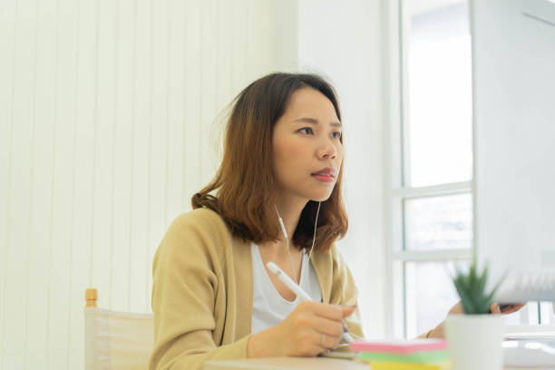 istock close up young asian woman frowned on face with messy hair while working with difficult tasks  at desktop in living room for work from home concept 1223831157