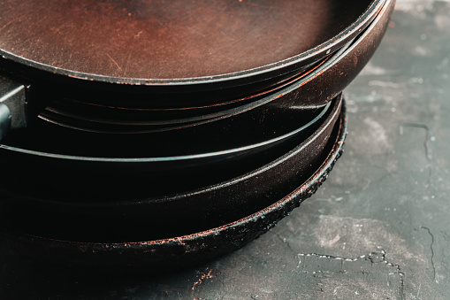 Clean vintage frying pans on the rustic background. Selective focus. Shallow depth of field.