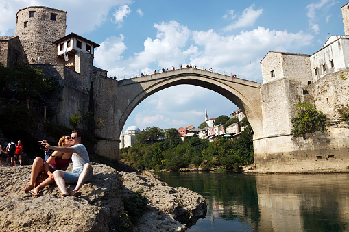 Mostar Bridge and tourists taking selfies in Bosnia and Herzegovina