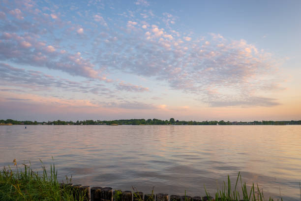 istock Colorful sheep clouds over a lake at sunset 1223834659